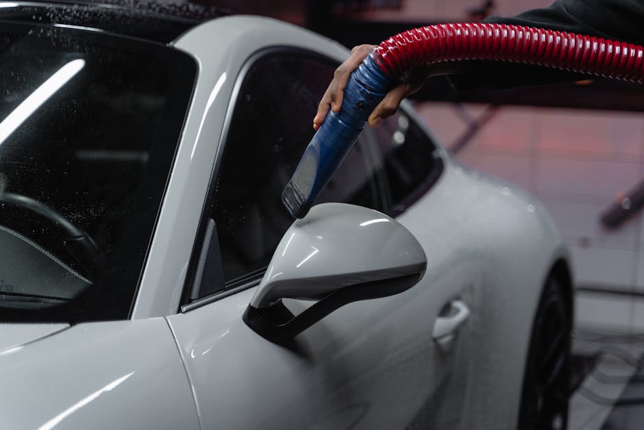 Detailer vacuuming the car interior